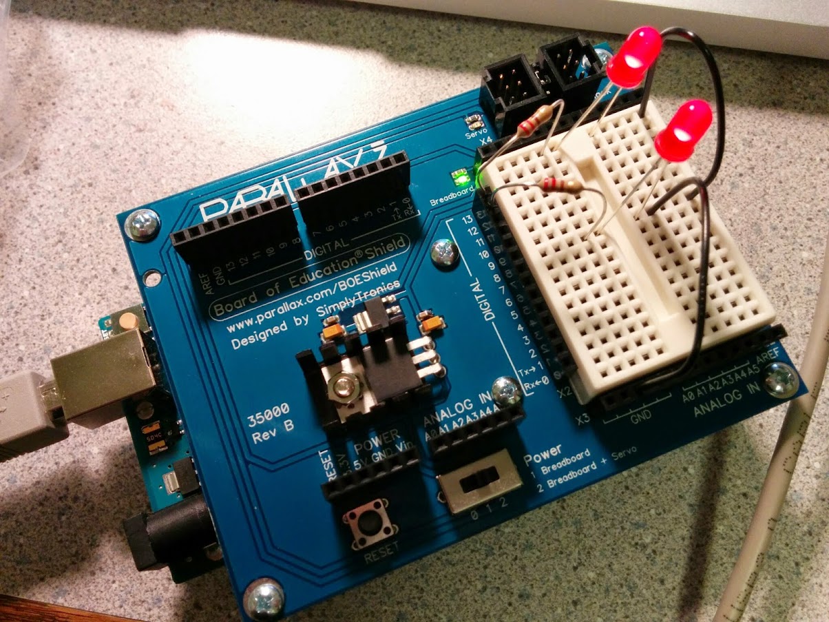 A close-up of the BOE shield breadboard with a simple LED circuit formed with 1 resistor per LED.